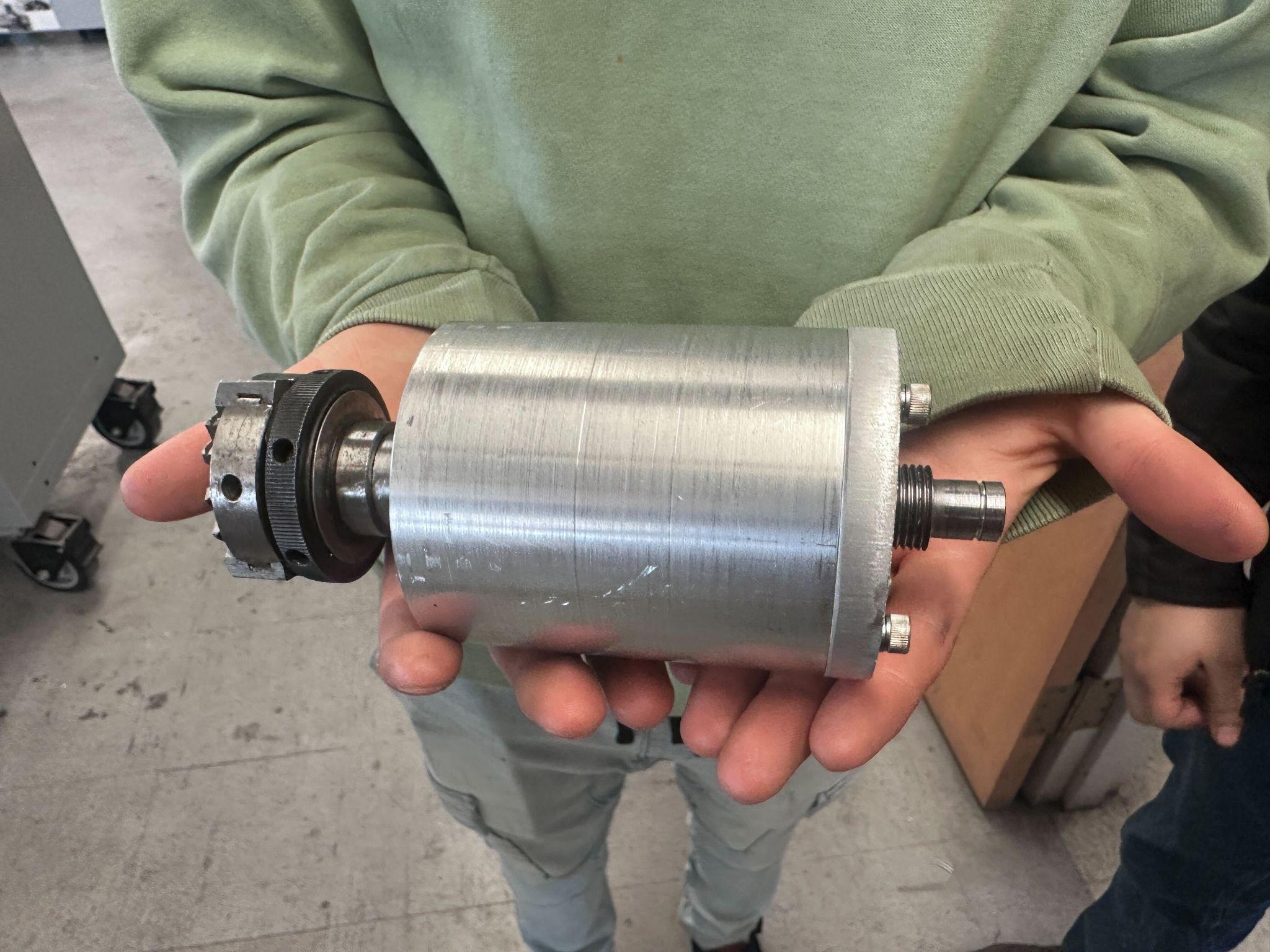 Machined headstock housing held in hand